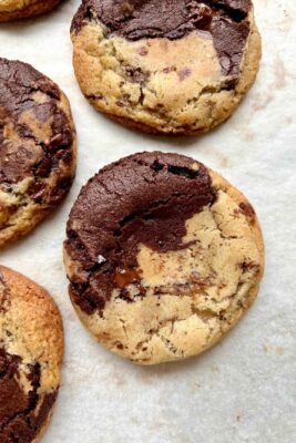 chocolate chocolate chip cookies on white parchment