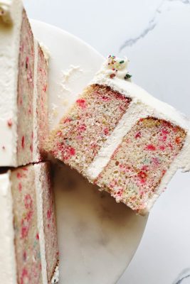 slices of confetti cake on cake stand