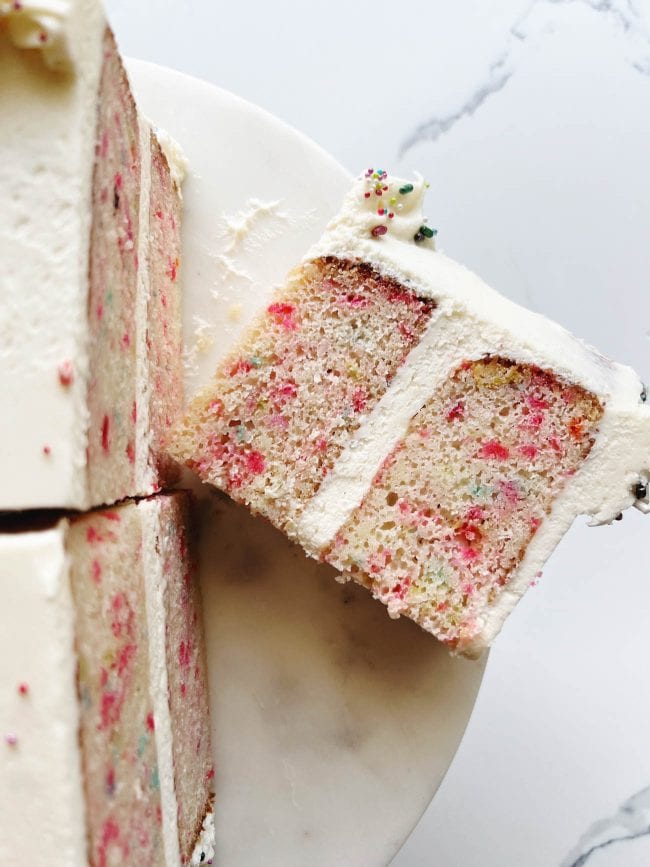 slices of confetti cake on cake stand