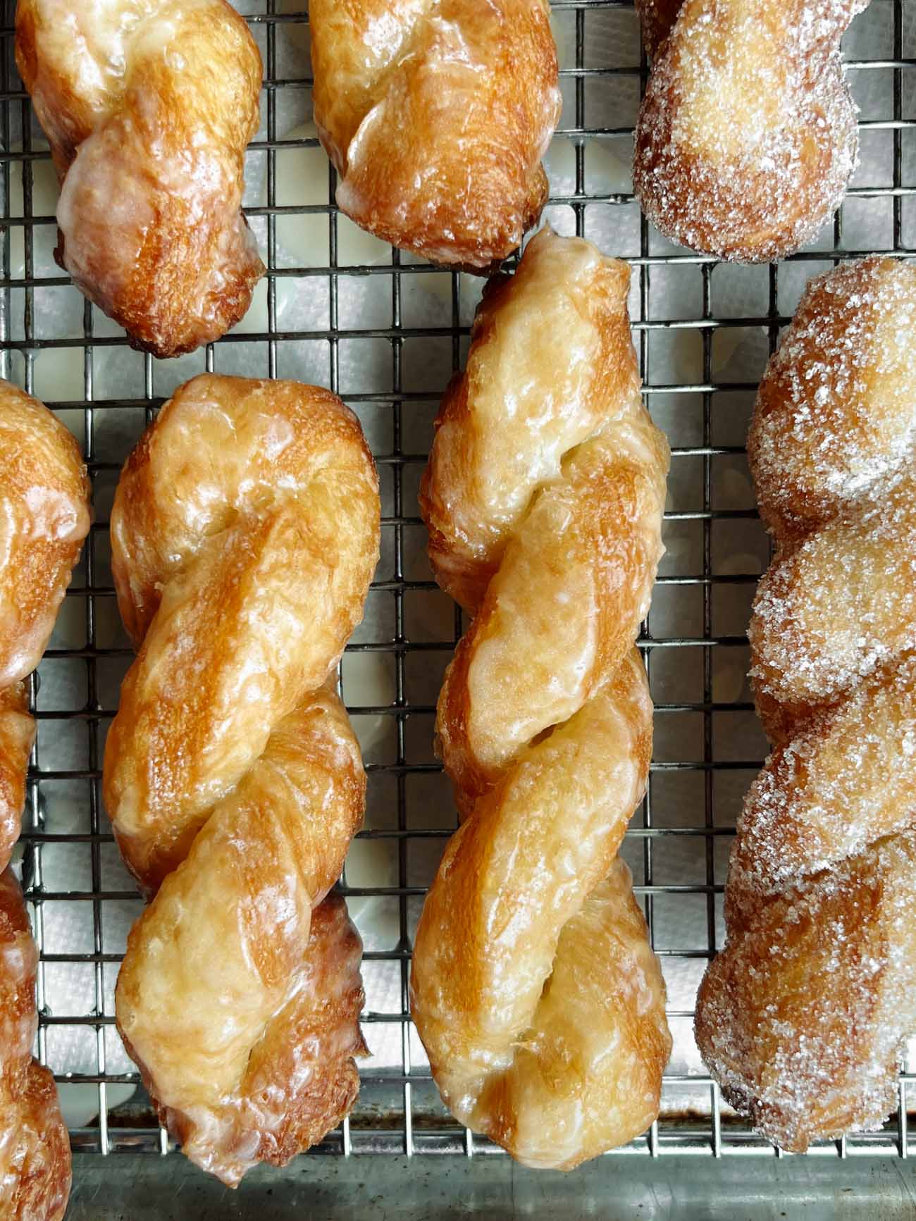 croissant twists on a wire rack 
