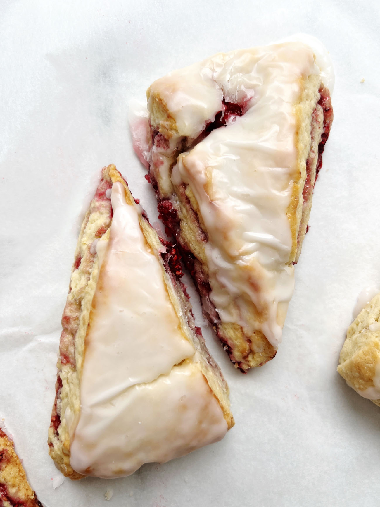 raspberry scones on parchment paper