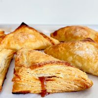 puff pastry apple turnovers on parchment