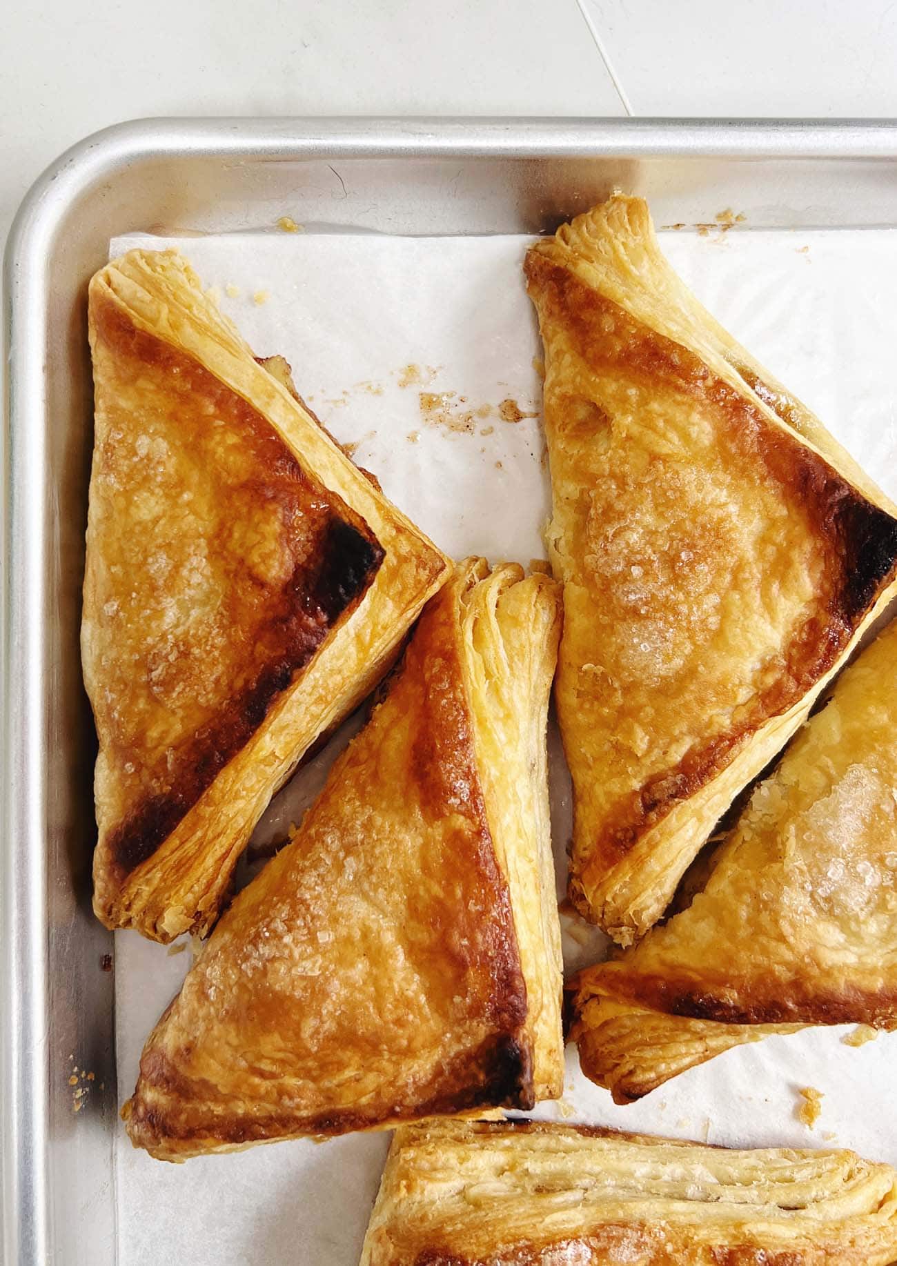 puff pastry apple turnovers on baking sheet