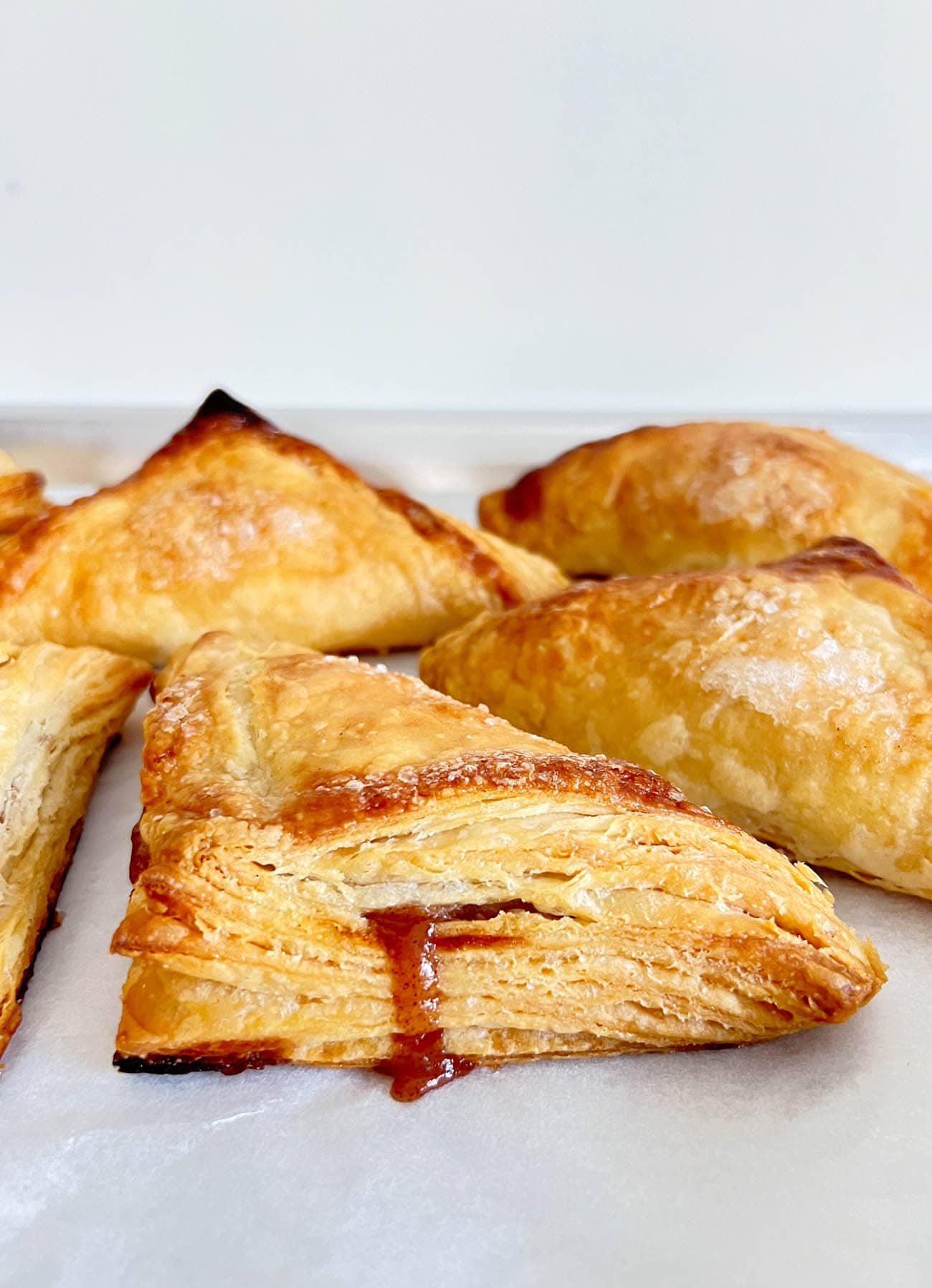 puff pastry apple turnovers on parchment