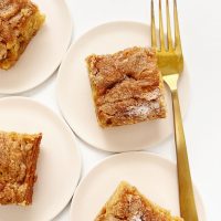 apple snack cake on pink plate with gold fork