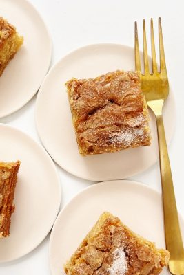 apple snack cake on pink plate with gold fork