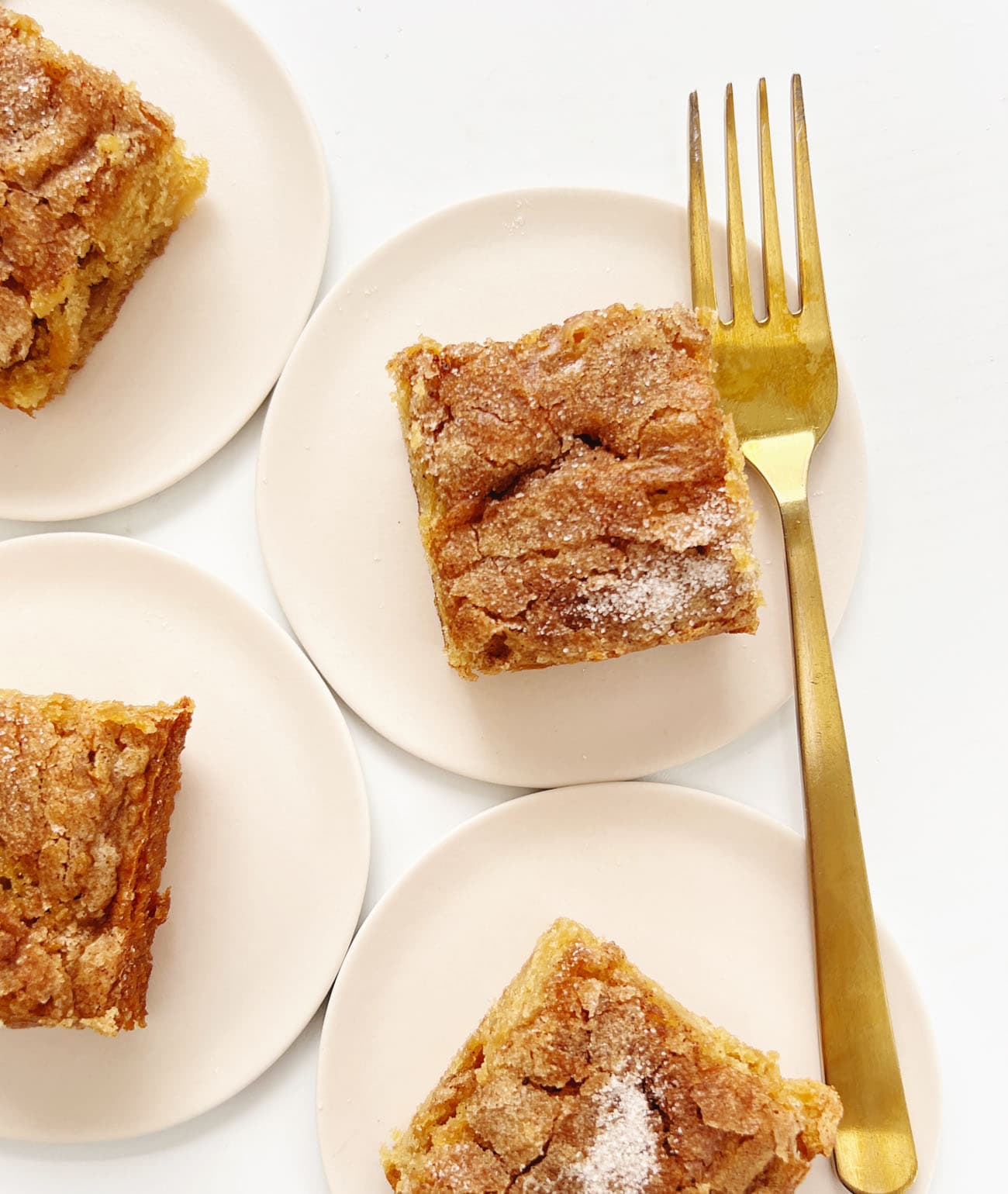 apple snack cake on pink plate with gold fork