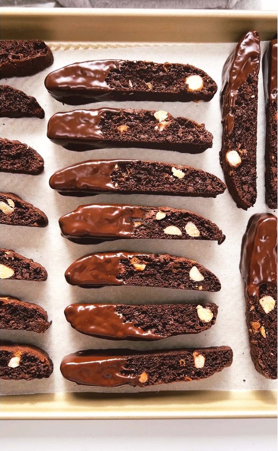 Chocolate dipped chocolate biscotti on baking tray