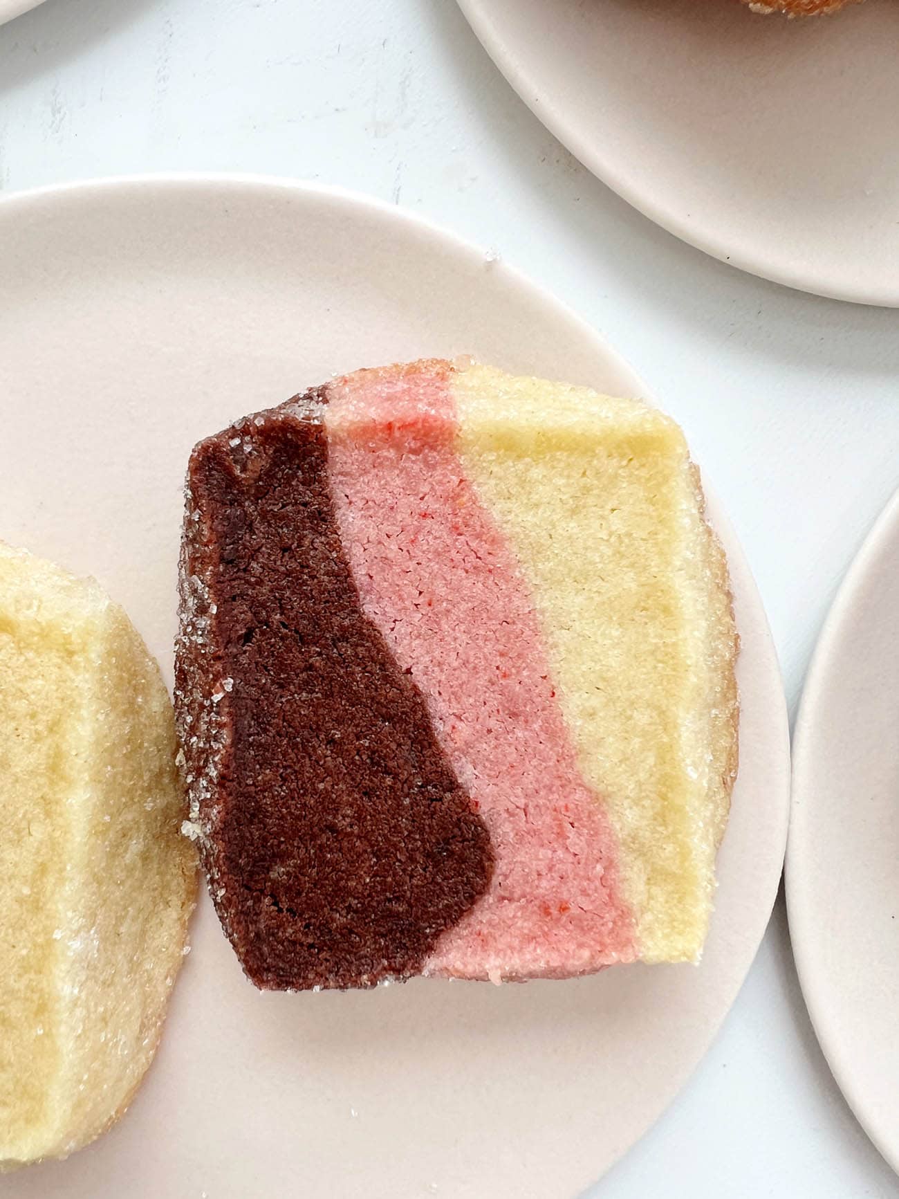 neapolitan shortbread cookies on pink plates