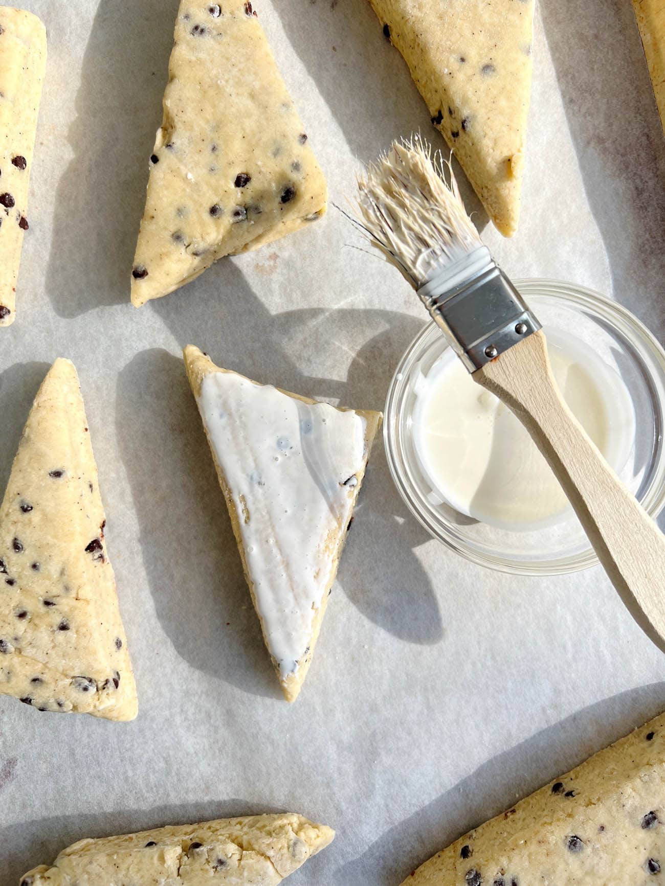 brushing cream on scones