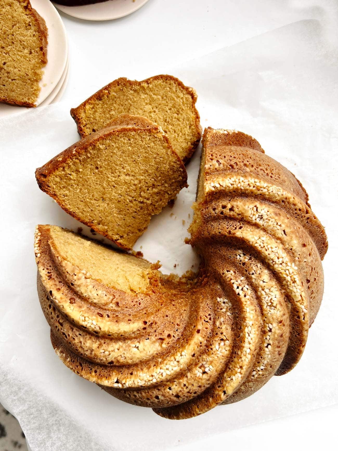 toasted sesame sourdough bundt cake on parchment paper